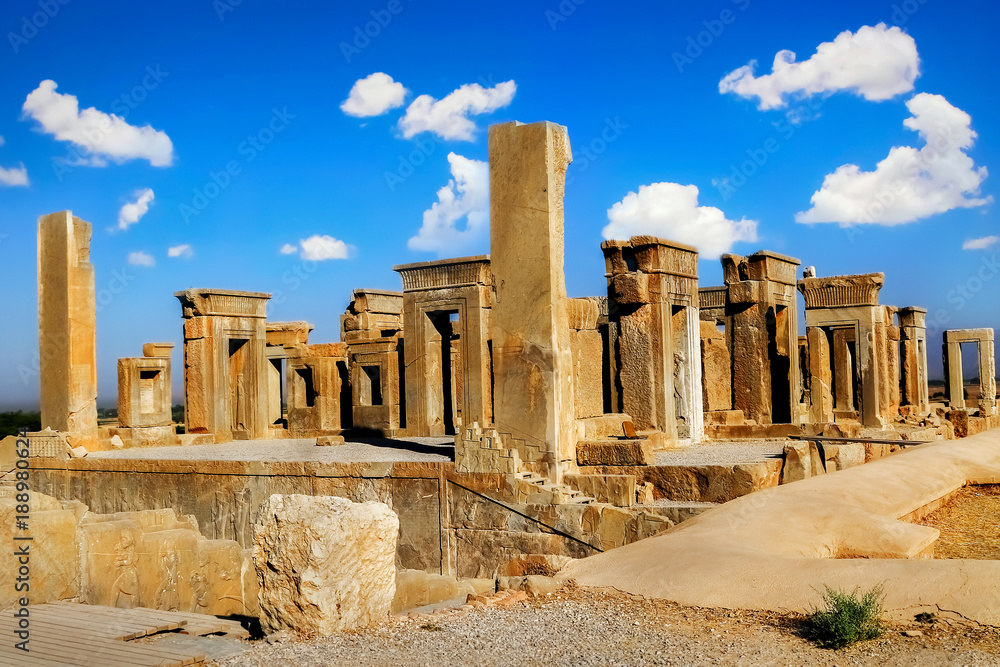 Persepolis is the capital of the ancient Achaemenid kingdom. Sight of Iran. Ancient Persia. Blue sky and clouds background.