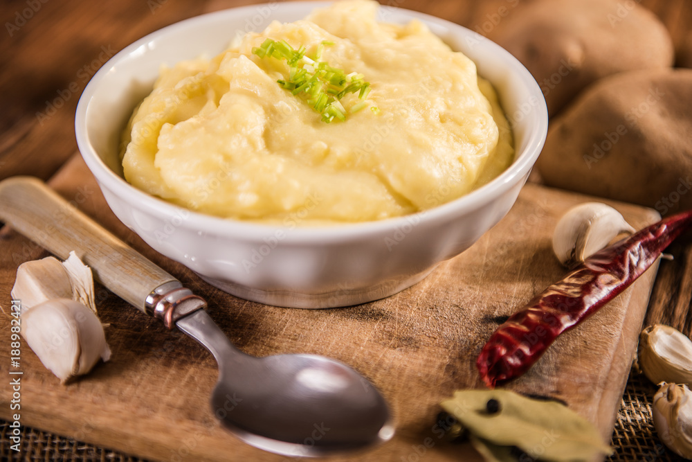 mash potatos in a white porcelain bowl on wood table mash potatos in a white porcelain bowl on wood table