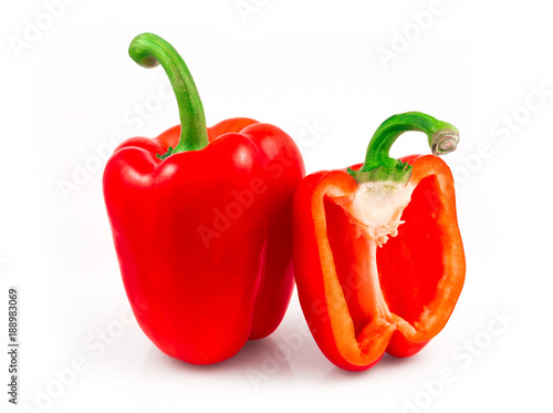 Whole and sliced red sweet peppers isolated on white background cutout