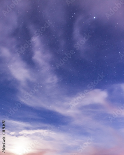 Starry sky and clouds illuminated by moonlight