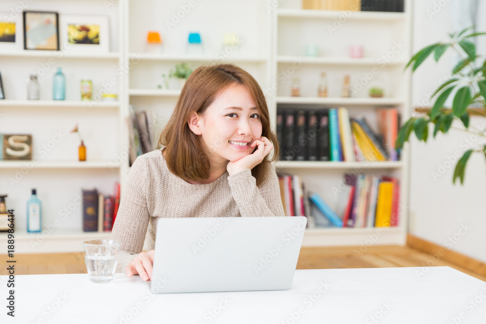 部屋でラップトップコンピューターを見る女性 部屋でラップトップコンピューターを見る女性