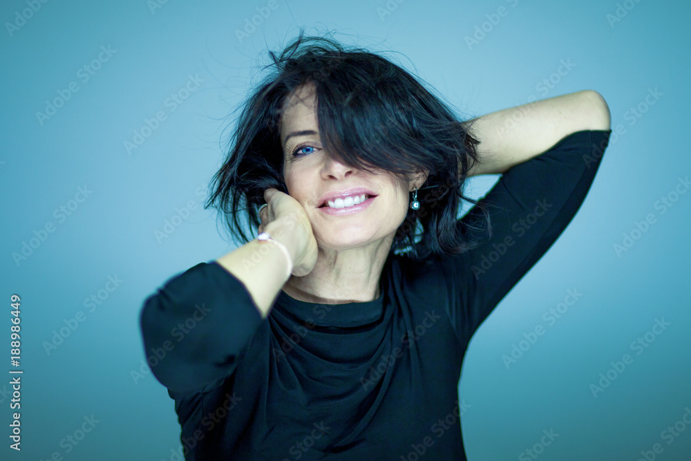 stunning beautiful and self confident middle aged woman with black hair smiling into camera portrait stunning beautiful and self confident middle aged woman with black hair smiling into camera portrait