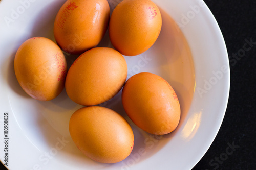 Brown eggs on a white plate