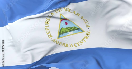 Nicaragua flag waving at wind with blue sky in slow, loop photo