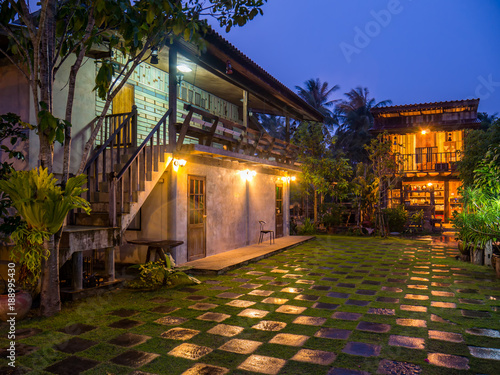 Vintage resort with check pattern of green yard in raining day at twilight
