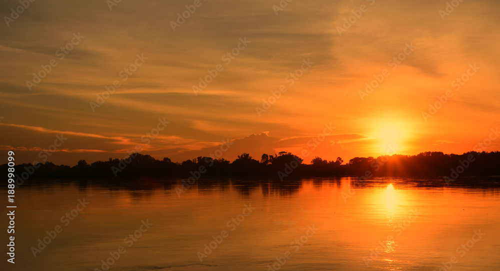 Beautiful sunset on the river bank./The sun is setting on the banks of the river. Create a beautiful natural light.