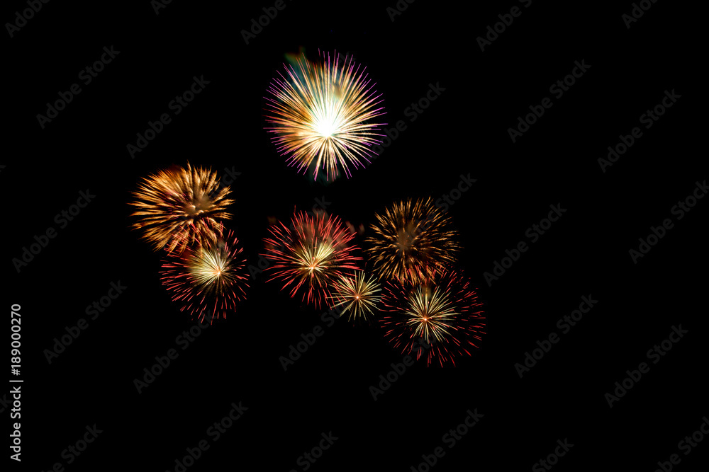 Colored firework background with free space for text. Colorful fireworks at night light up the sky with dazzling display. Use for abstract background.