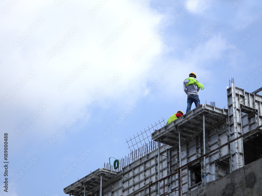 Construction workers working at height without wearing proper safety gear like body harness. This dangerous act can cause accidents and death.
