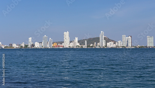 Modern Cartagena along the sea shoreline beaches. Scenic view from the sea harbor on the modern multistory buildings in Cartagena, Colombia. © avmedved