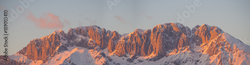 Presolana is a mountain range of the Orobie, Italian Alps. Landscape in winter. At sunset the rocks become red, orange and pink