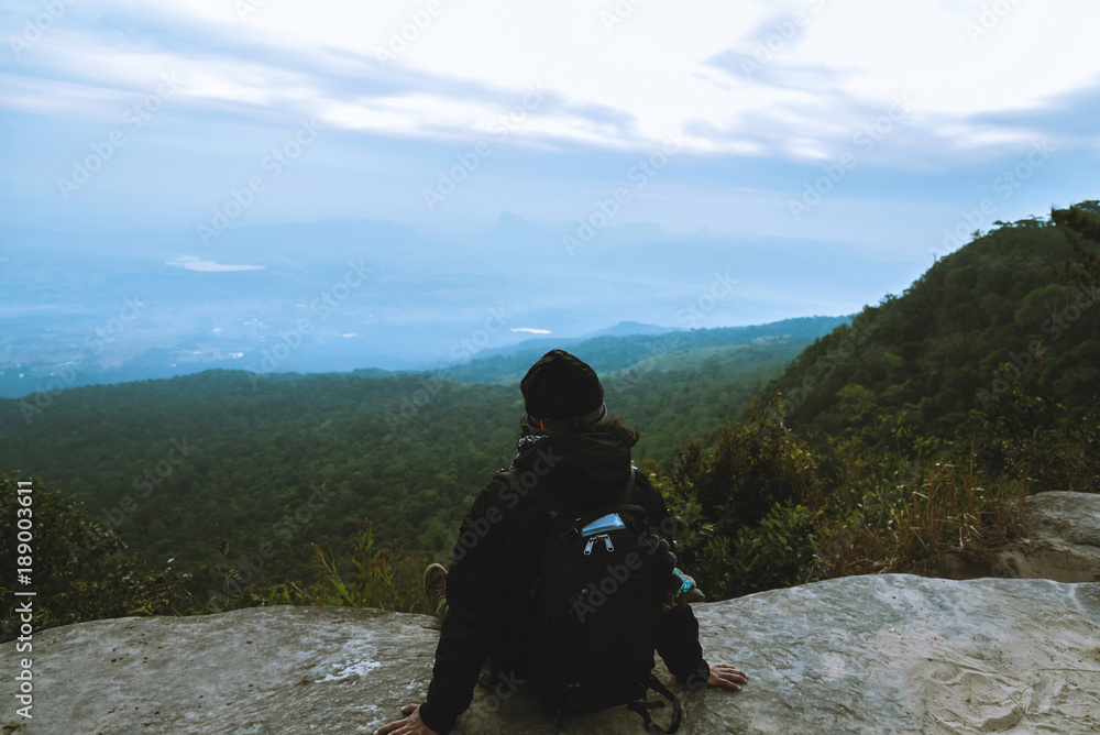 Men asians travel relax in the holiday. Admire the atmosphere landscape on the Moutain. Mountain Park happily. In Thailand