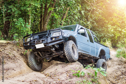 4 wheel drive is climbing on a difficult off-road in mountain forests in Thailand.