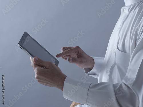 Saudi Arabian Man Hands Holding Tablet photo