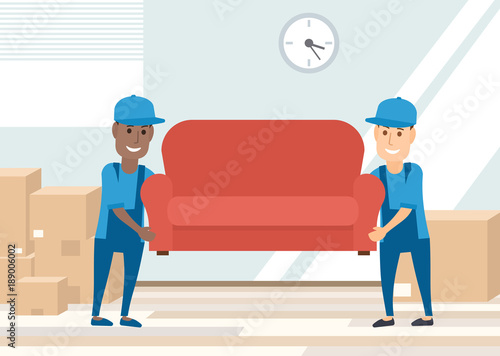 two movers carrying sofa. moving day concept