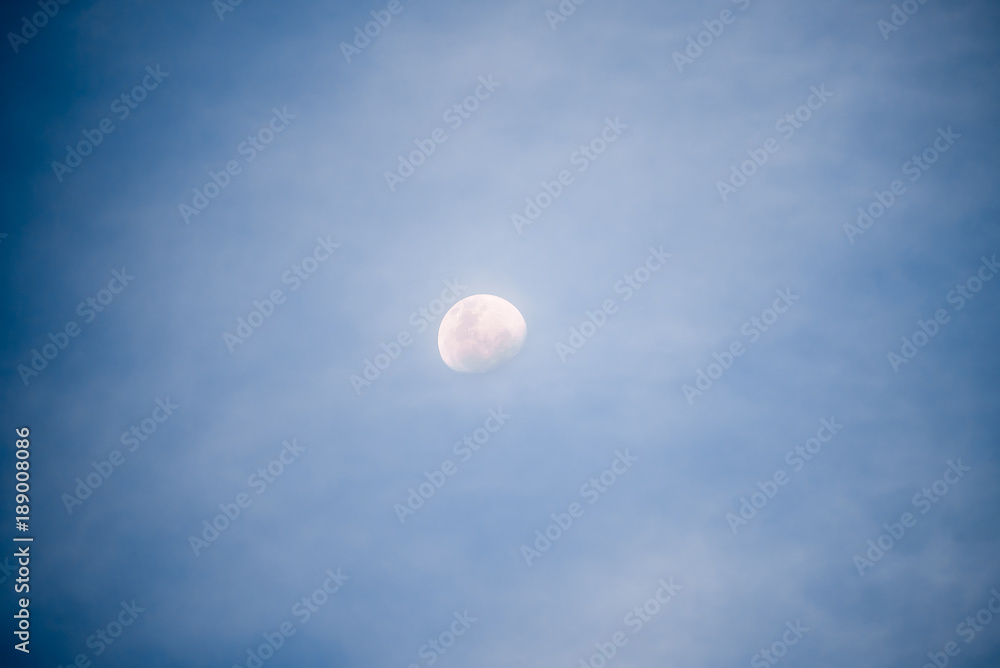 Waxing gibbous moon at night with illuminated sky Waxing gibbous moon at night with illuminated sky
