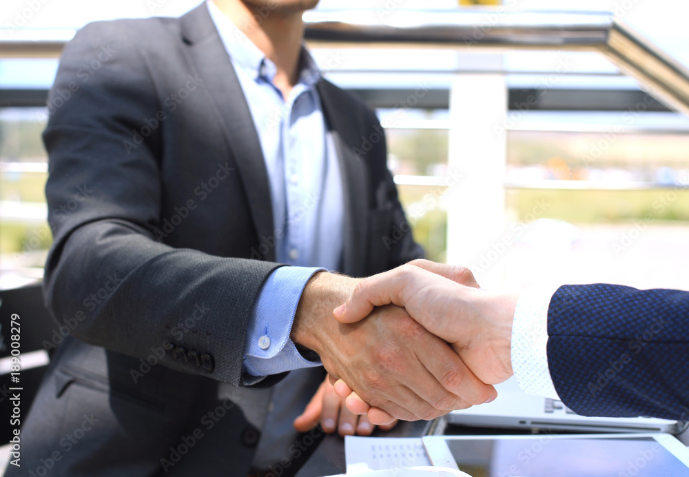 Business people shaking hands, finishing up a meeting. Business people shaking hands, finishing up a meeting.