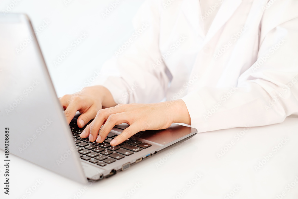 Scientist or doctor hand typing on laptop notebook keyboard for test result. Scientist or doctor hand typing on laptop notebook keyboard for test result.