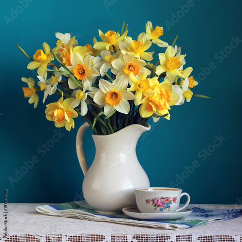 Bouquet of daffodils in a white jug. Flowers in a vase.