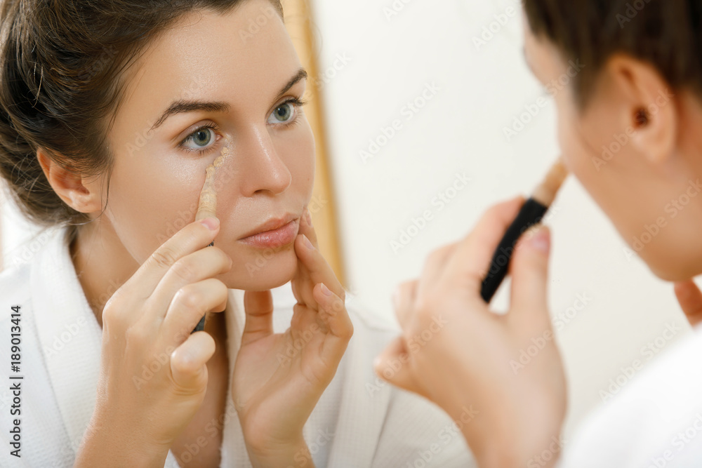 Woman using concealer Woman using concealer
