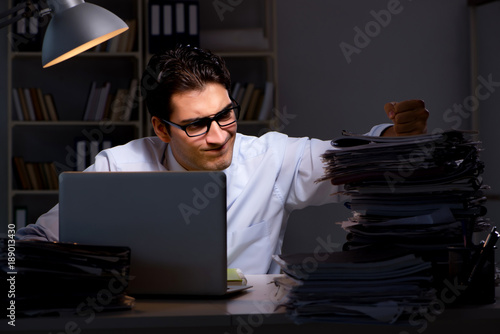 Young businessman working overtime late in office