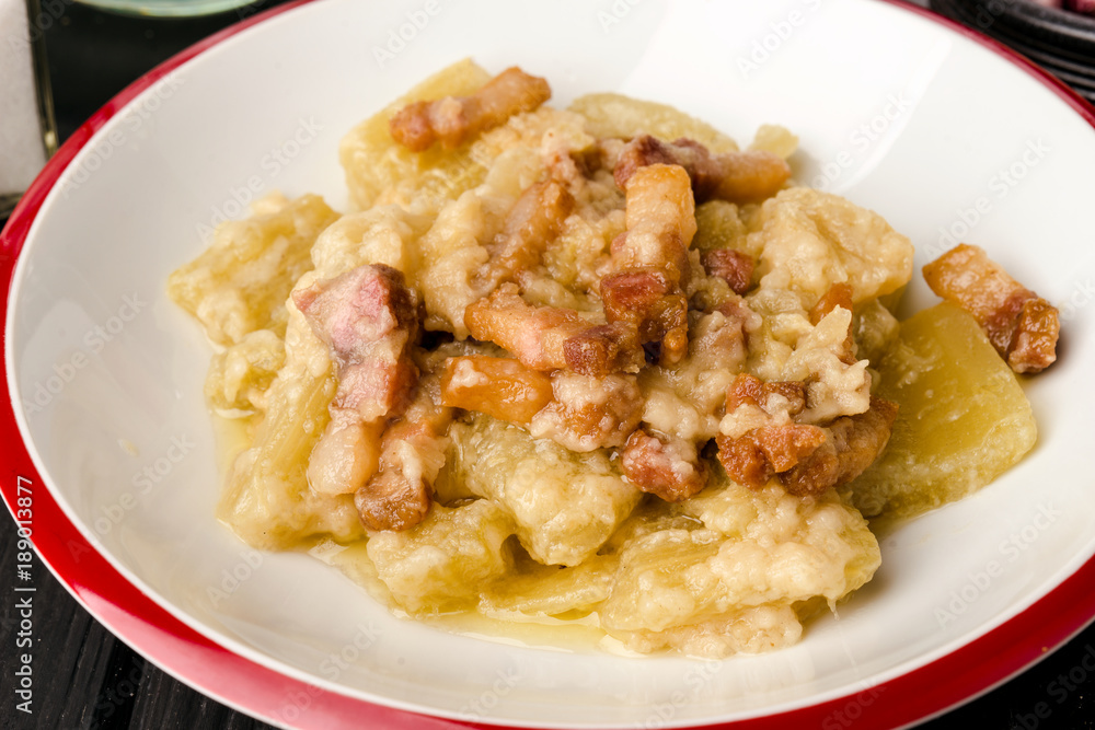 Fototapeta homemade cooked meal of stew thistle with Iberian bacon on modern black board