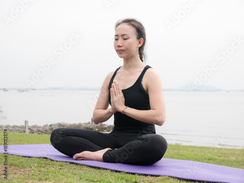 young woman practice yoga on the beach