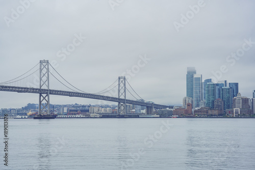 The beautiful skyline of San Francisco with the Oakland Bay Bridge in a cloudy day