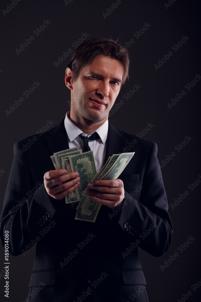 Photo of banker in suit counting dollars Photo of banker in suit counting dollars