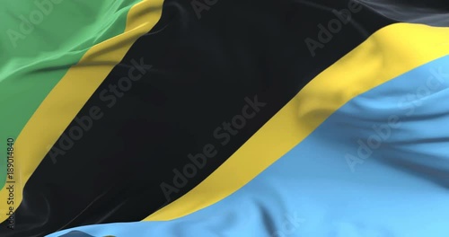 Tanzania flag waving at wind in slow in blue sky, loop photo