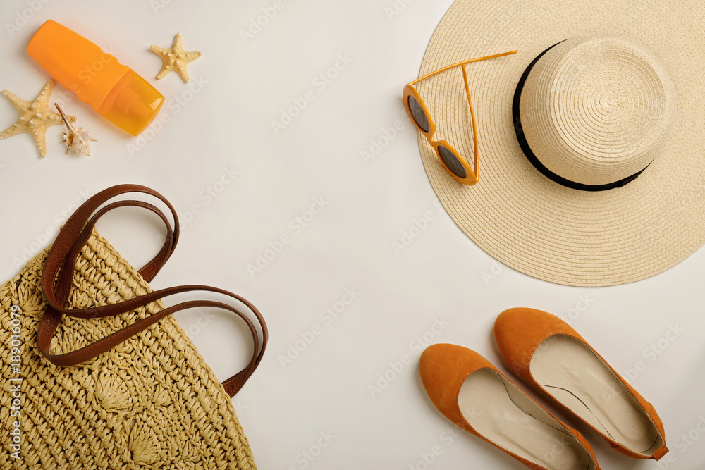 Φωτογραφία Fashion accessories for the beach - hat, ballet shoes, orange glasses and sunscreen on a white background