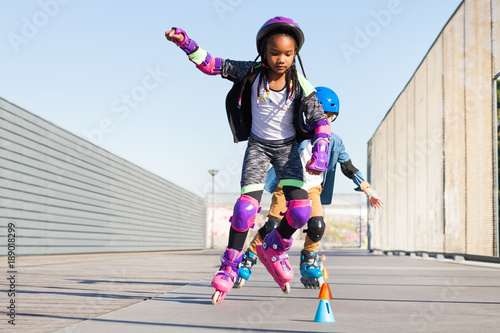 Girl learning to slalom skate with inline skates