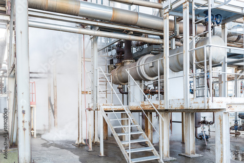 Fragment of the technological installation in the factory. Steam leak.