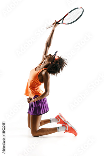 Side view of happy young tennis girl holding racket and gesturing isolated on white background. Strength and motivation