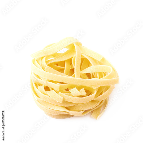 Uncooked fettuccine pasta isolated