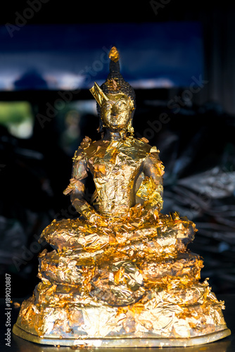 small buddha figure in gold leaf close-up