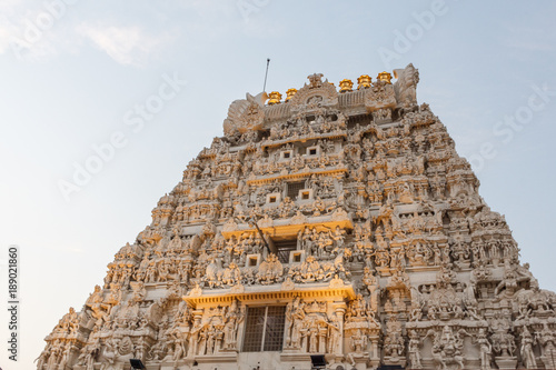 Ancient temple tower view of Kanchi kamakshi amman temple illuminated with lights. Low light photography during sunset.