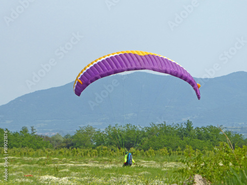 Paraglider landing in a field