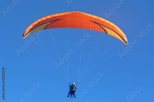 Tandem paraglider flying