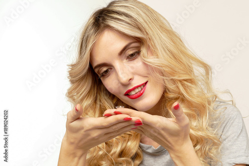 Beautiful blond woman with contact lenses box.