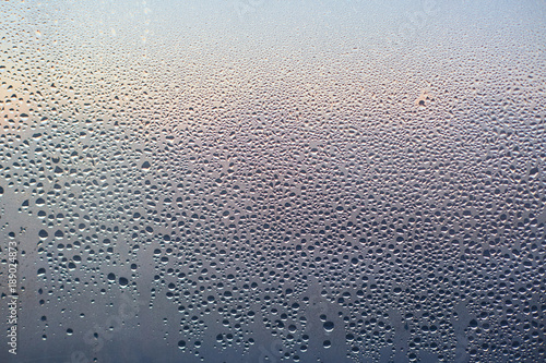Rain drops on glass background. Pattern of water drops after heavy rain, View from indoor. Abstract wet texture. Transparent drops of different shapes