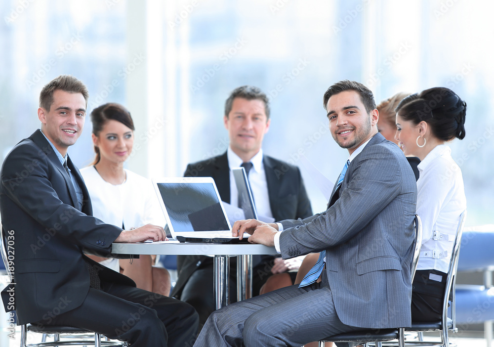 group of smiling business people sitting in a meeting room. group of smiling business people sitting in a meeting room.