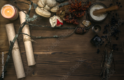 Ancient magic scroll on wooden desk table. Witchcraft. Witch doctor desk table. Magic potion. Alternative medicine concept. photo