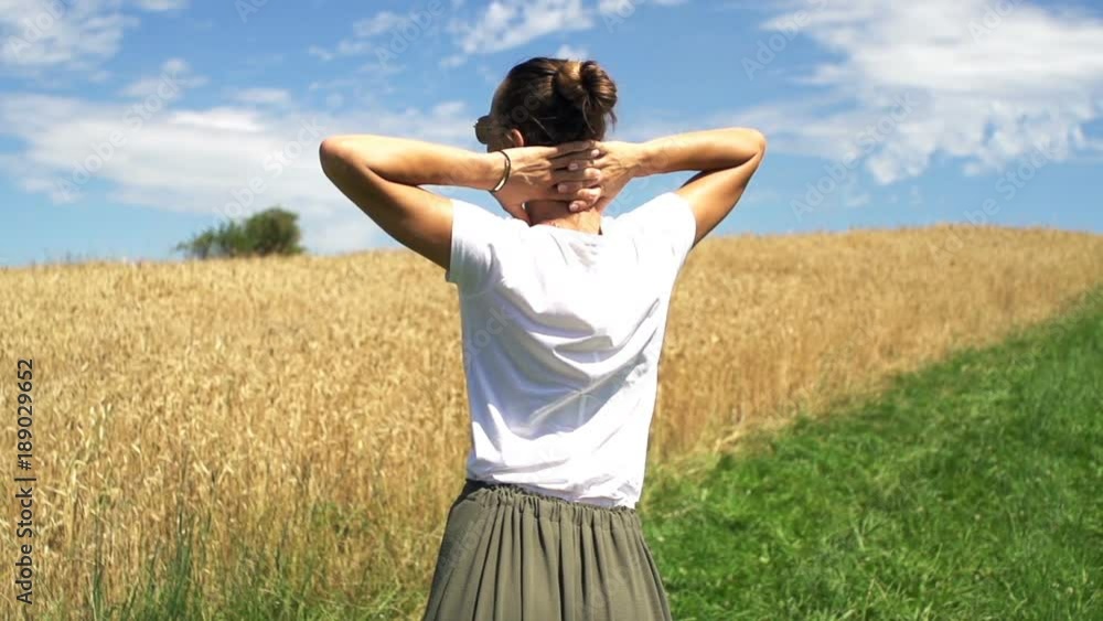 Woman stretching arms and admire wheat field in country
Woman stretching arms and admire wheat field in country