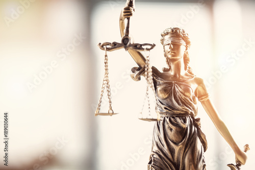 Justice blindfolded lady holding scales and sword statue