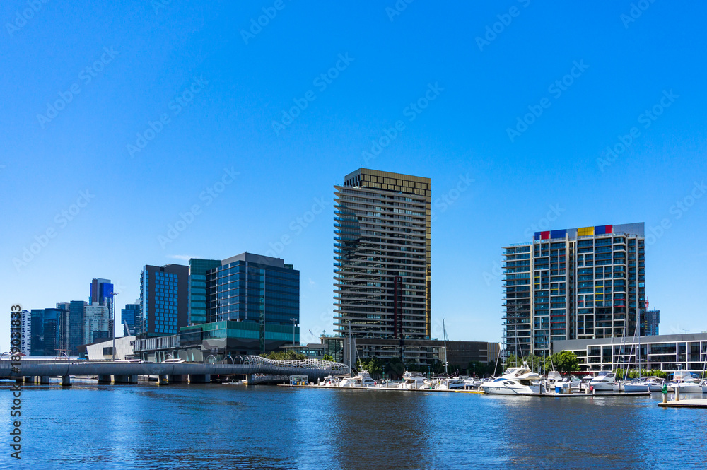 Modern buildings on the bank of river on sunny day