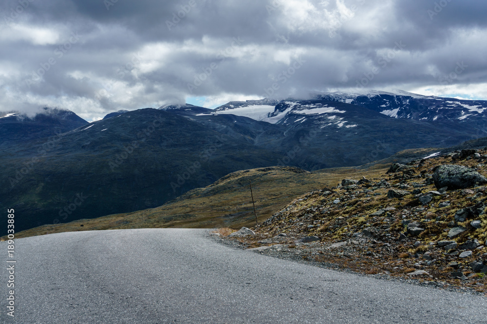Street in Norway with mountains and clouds