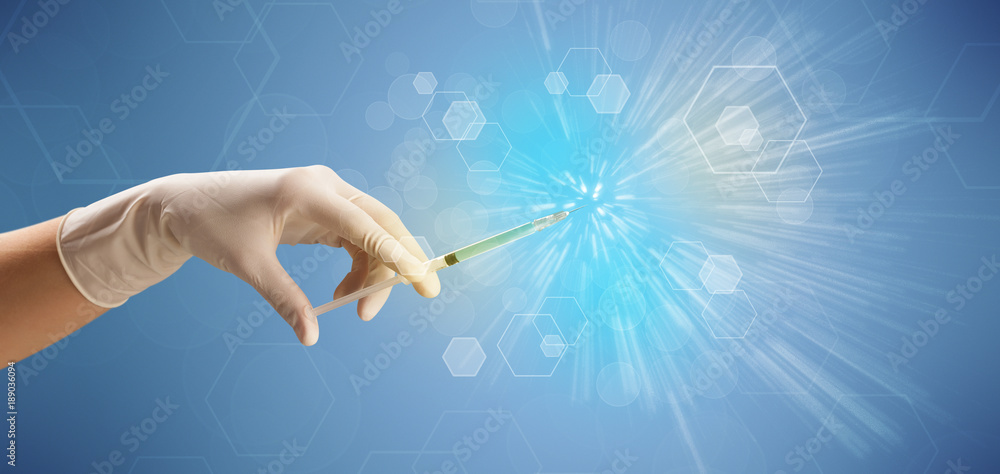 Female doctor holding syringe Female doctor holding syringe