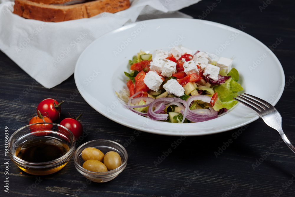Close up of tasty greek salad with fresh vegetables