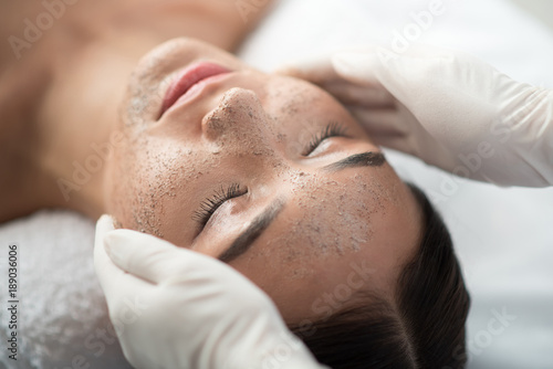 Принти на полотні Close up of young woman getting facial skin treatment at spa
