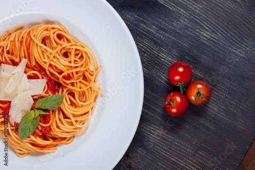 Flat lay of tatsy sphaghetti with tomatoes photo